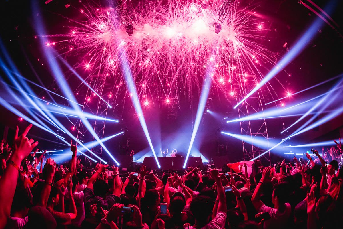 Crowd and pyrotechnics at a live music night