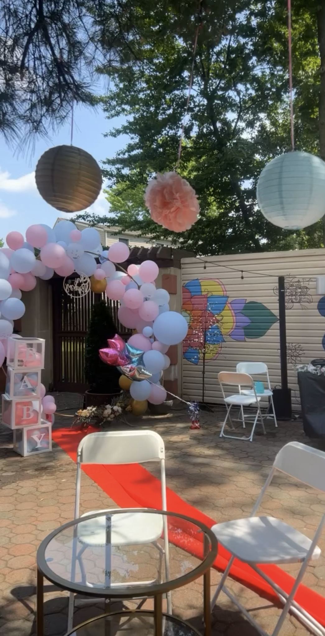 Pink and blue gender reveal décor with dessert table