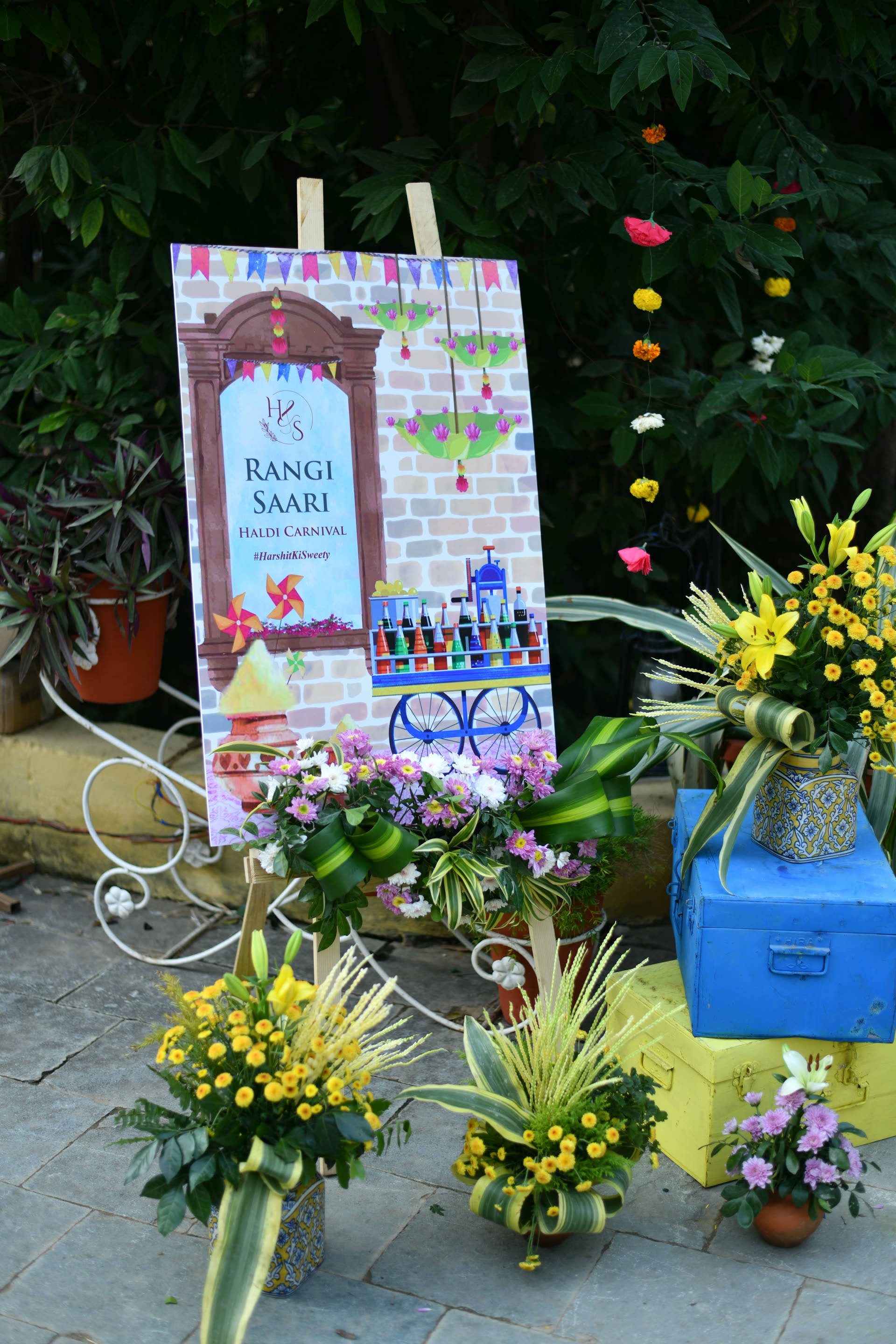 Hand-painted carnival signage and floral styling at a cultural celebration