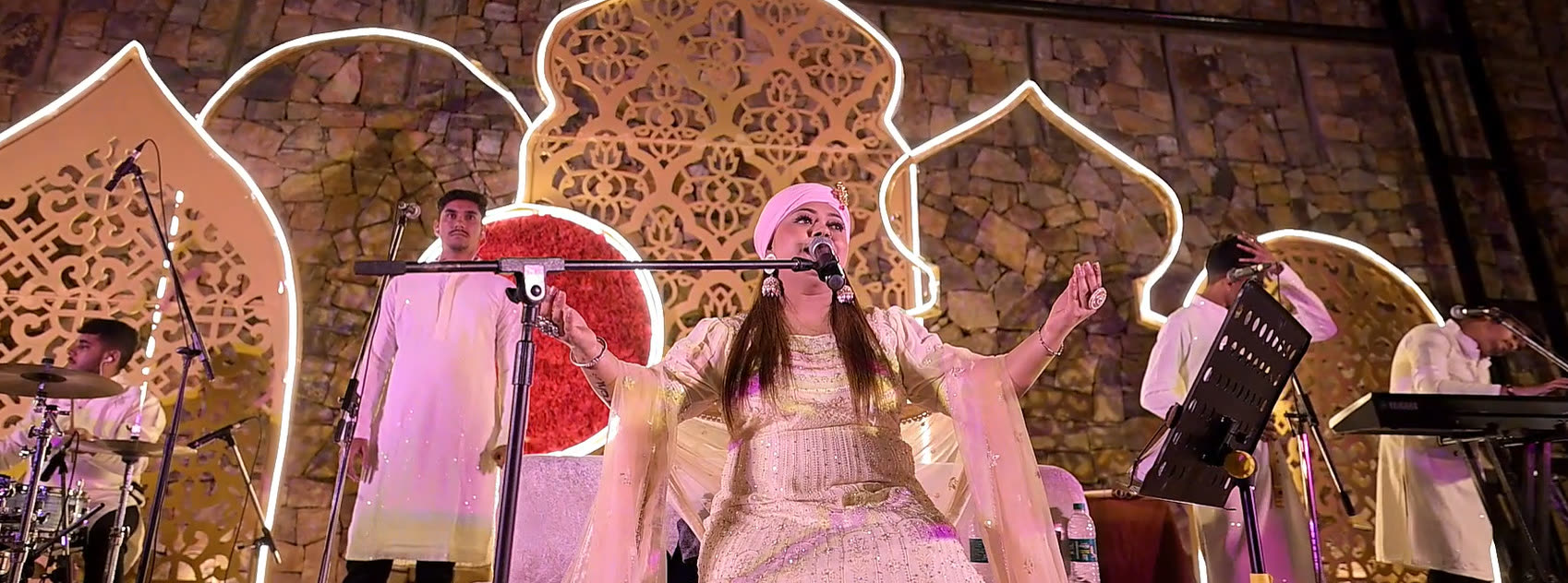 Singer performing on a decorated cultural stage
